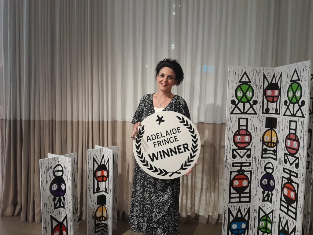 Jodie Atkinson holding an Adelaide Fringe Winner award